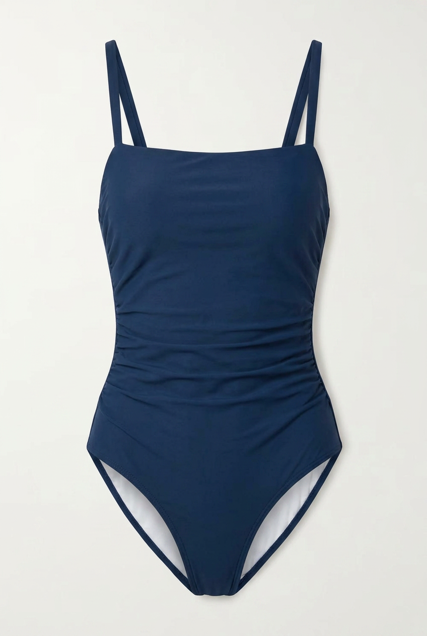 Navy blue swimsuit with thin straps on a light gray background