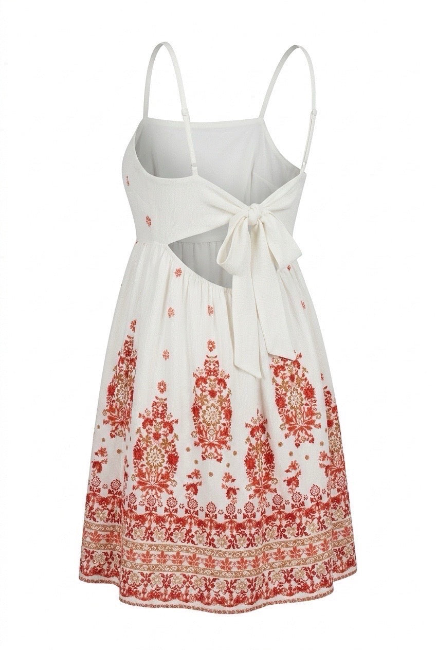 White dress with red floral patterns on a white background