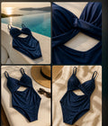 Navy blue swimsuit with cut-out design on a sunlit surface, poolside.