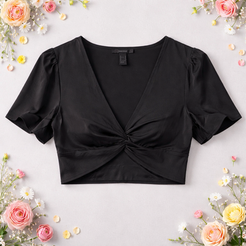 Black crop top with puff sleeves on a light gray background with flowers