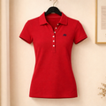 Red polo shirt on a hanger against a beige wall