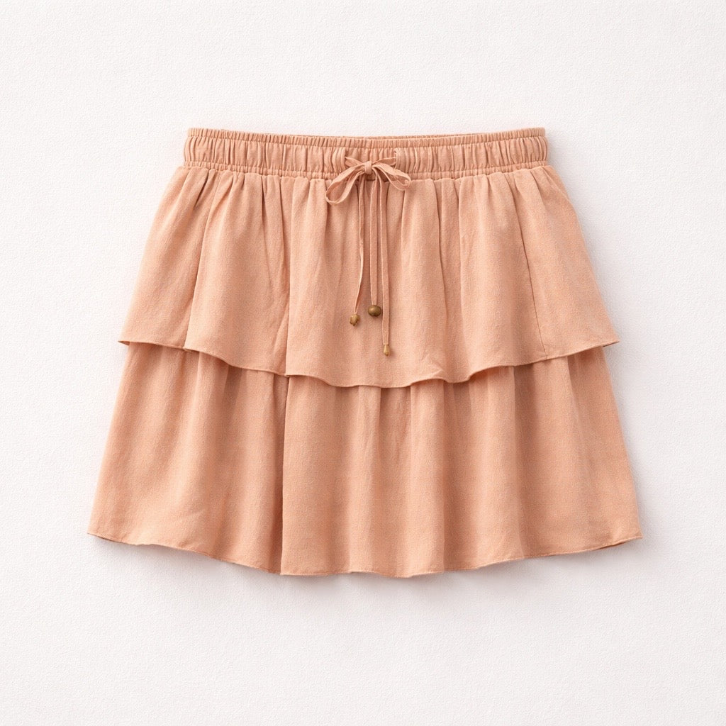 Pink tiered skirt on a light gray background