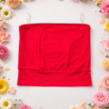 Red tube top on a white background with flowers around
