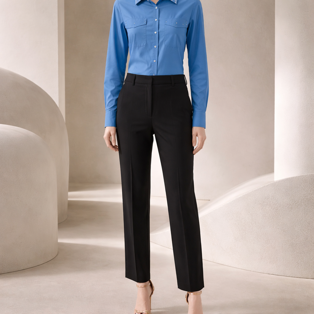 Person wearing a blue shirt and black pants in a minimalistic setting