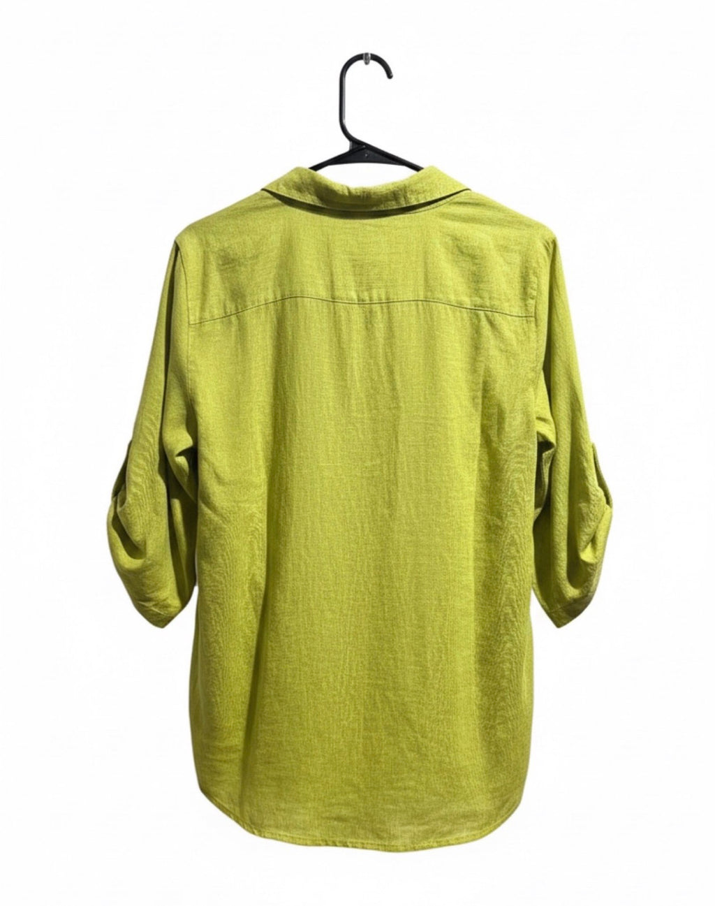 Green shirt on a hanger against a white background