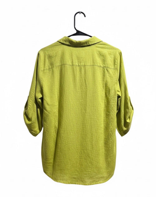 Green shirt on a hanger against a white background
