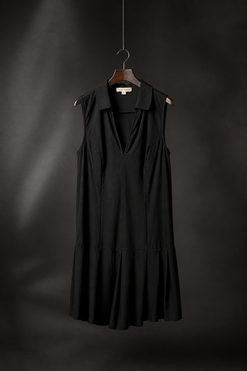 Black sleeveless dress hanging on a dark background