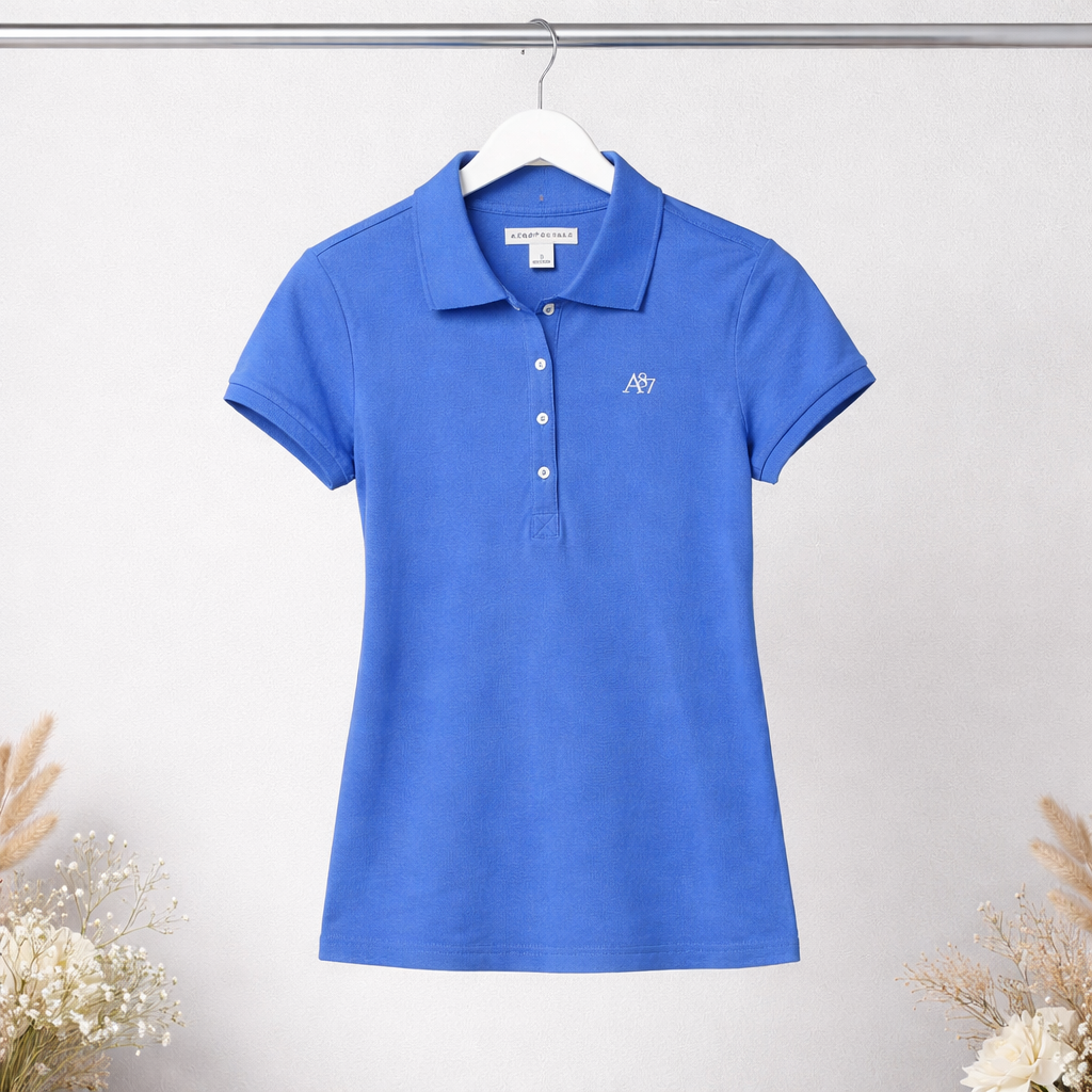 Blue polo shirt on a hanger against a light gray background