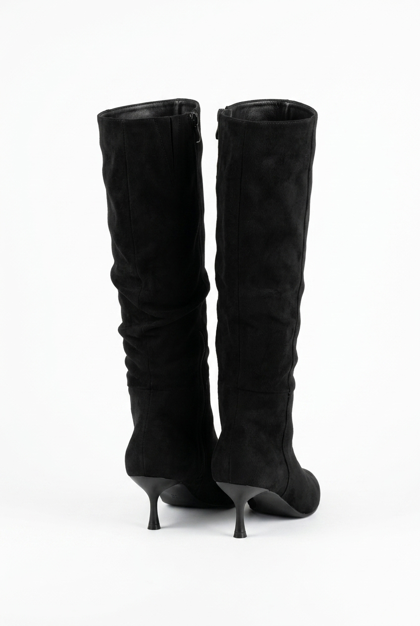Black knee-high boots on a white background