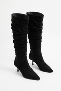 Black knee-high boots on a white background