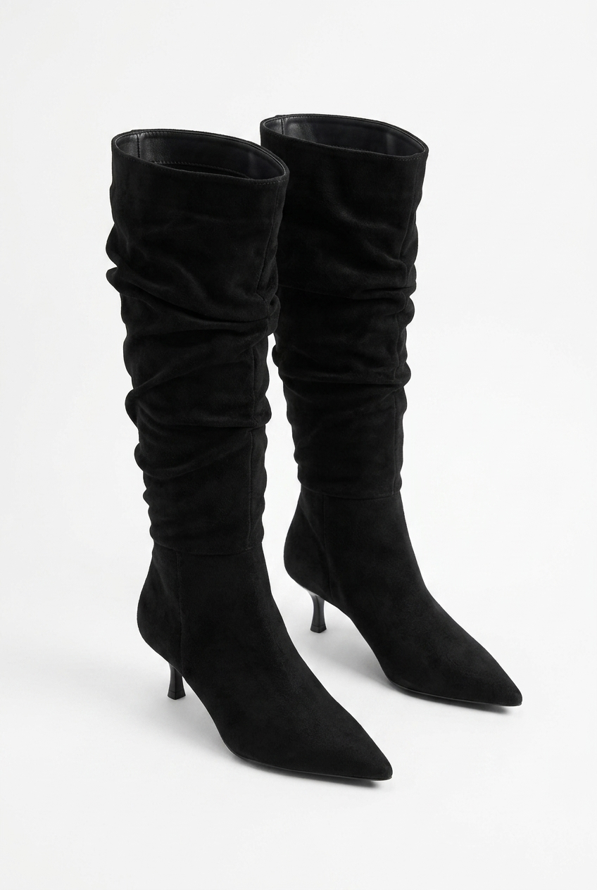 Black knee-high boots on a white background