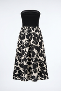 Black strapless top with a floral patterned skirt on a white background