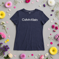 Navy Calvin Klein t-shirt surrounded by colorful flowers on a gray background